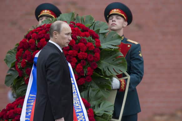Vladimir Putin takes part in a wreath laying ceremony at the Tomb of the Unknown Soldier outside Moscow`s Kremlin Wall, in Moscow, Russia, to mark the 72nd anniversary of the Nazi invasion of the Soviet Union.
