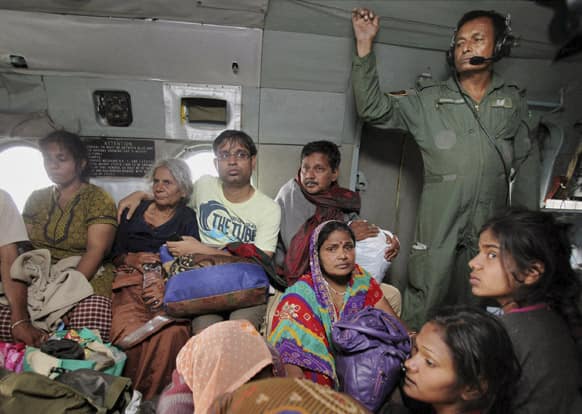 Pilgrims sit inside an Indian Air Force (IAF) aircraft after they were rescued from the flood affected areas, in Gauri Kund, in Uttarakhand.