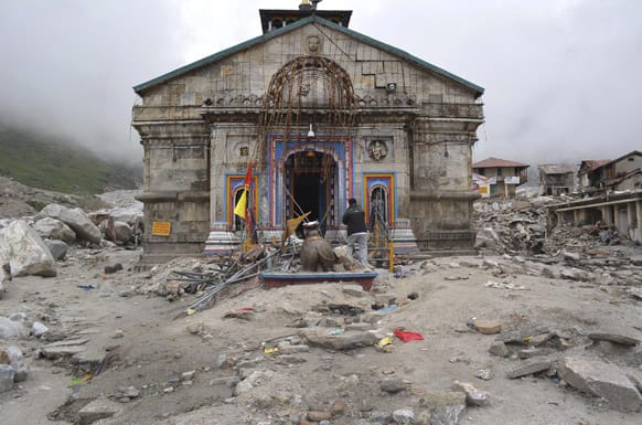 The Kedarnath shrine, one of the holiest of Hindu temples dedicated to Lord Shiva, and other buildings around it are seen damaged following monsoon rains in at Kedarnath in Uttrakhand.
