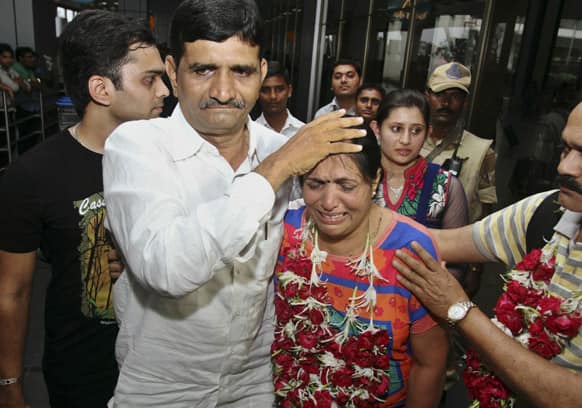 Ashok Radadiya consoles his flood affected sister Sudhaben Bhalala upon her arrival in Ahmadabad.