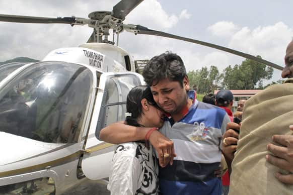 A flood hit couple console one another after being evacuated by helicopter from the upper reaches of Uttrakhand, in Dehradun.