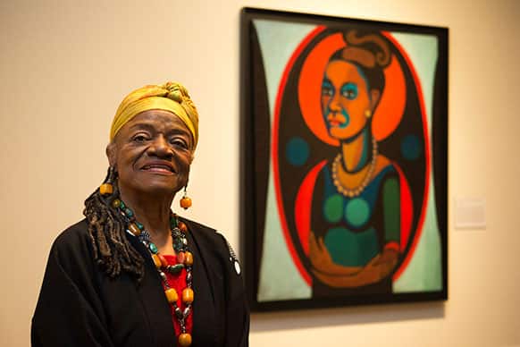 Artist Faith Ringgold poses for a portrait in front of a painted self-portrait during a press preview of her exhibition,