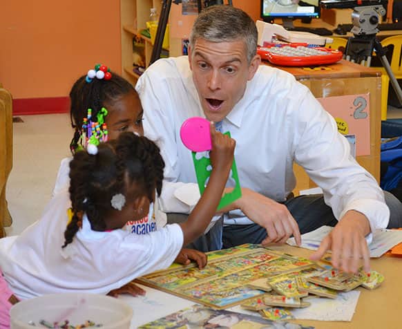 US Education Secretary Arne Duncan visits with young students at the St. Benedict Center for Early Childhood Education in Louisville, Ky. Duncan is touting President Barack Obama`s $75 billion proposal for a huge expansion of early childhood learning.