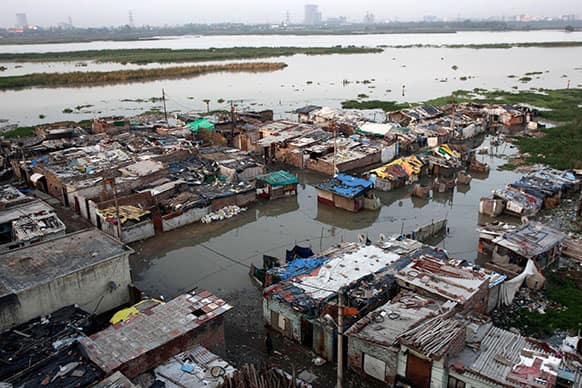 A shanty town along the banks of the Yamuna River lies partially submerged in floodwater, in New Delhi.