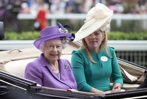 Britain`s Queen Elizabeth II arrives by carriage with Autumn Phillips on the third day traditionally known as Ladies` Day of the Royal Ascot horse race meeting, in Ascot.