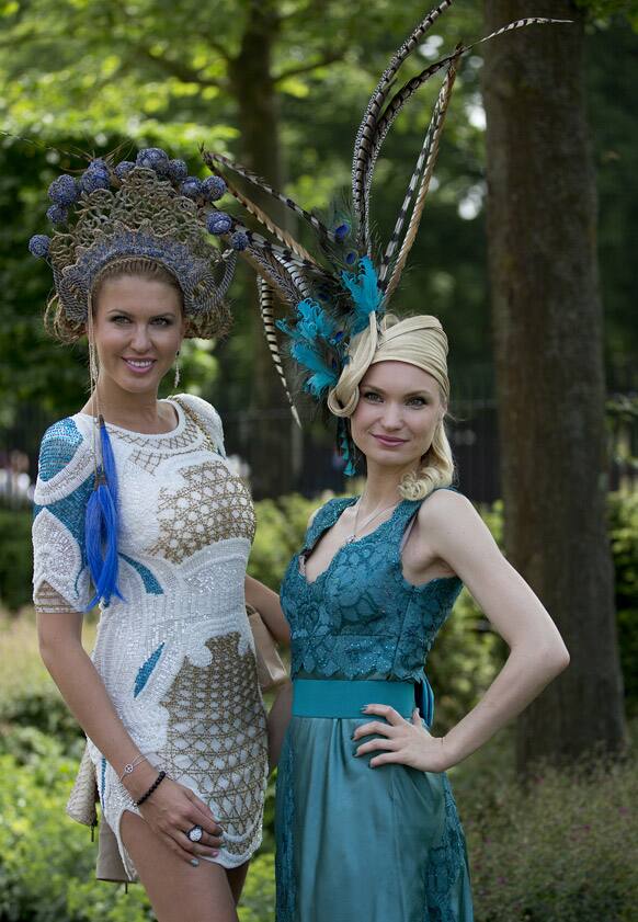 Marinilia Smirnova, right, and Natalia Kapchuck pose for the media wearing ornate hats on the second day of the Royal Ascot horse race meeting in Ascot, England.
