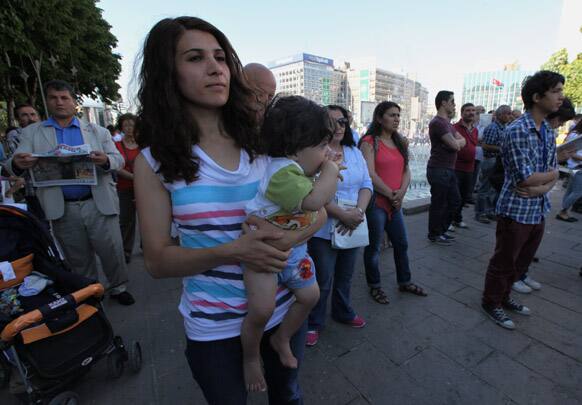 People stand in a silent protest in Guven Park in Ankara. After weeks of sometimes-violent confrontation with police, Turkish protesters have found a new form of resistance: standing still and silent.