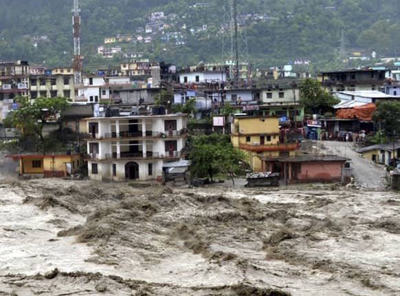 Houses are partly submerged in the flooded River Ganges in Uttarakashi district, in the northern Indian state of Uttarakhand.
