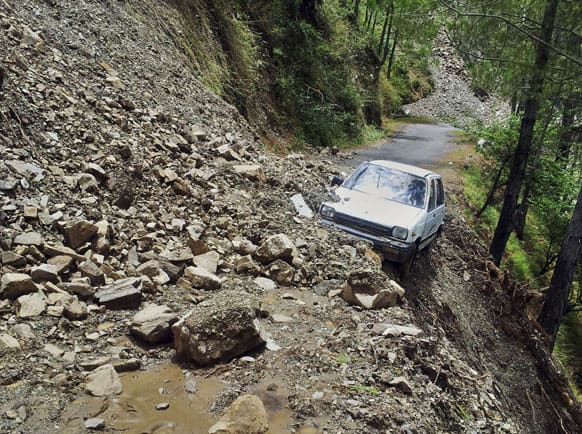 A car is abandoned in rubble from a landslide in Tehri, the northern Indian state of Uttarakhand.