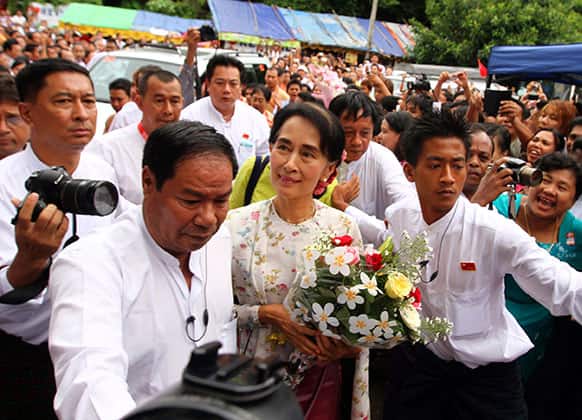 Myanmar opposition leader Aung San Suu Kyi arrives to attend a ceremony to mark her 68th birthday at the headquarters of her National League for Democracy (NLD) party in Yangon, Myanmar.