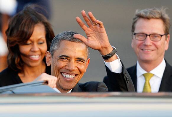 US President Barack Obama waves after disembarking from Air Force One at the Tegel airport in Berlin.