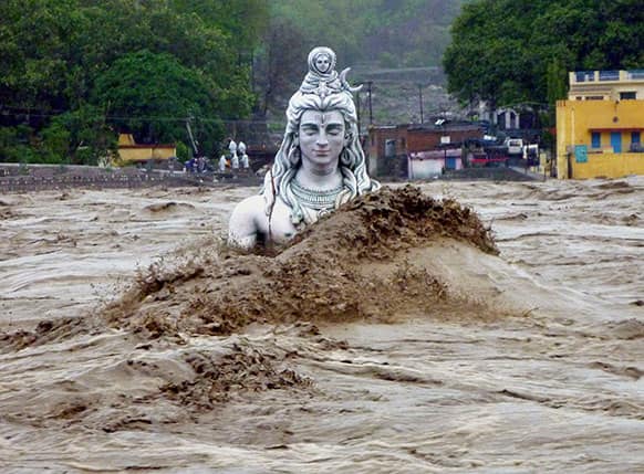 A submerged idol of Hindu Lord Shiva stands in the flooded River Ganges in Rishikesh, in the northern Indian state of Uttarakhand.