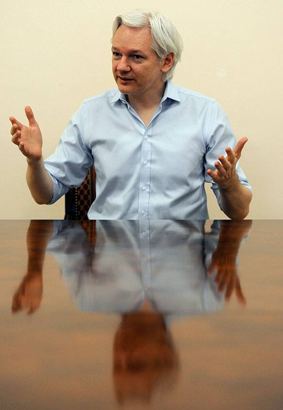 Julian Assange speaks to the media inside the Ecuadorian Embassy in London ahead of the first anniversary of his arrival there on June 19, 2012.
