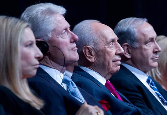 Israeli President Shimon Peres sits with former US President Bill Clinton during Peres` 90th birthday gala in Jerusalem.