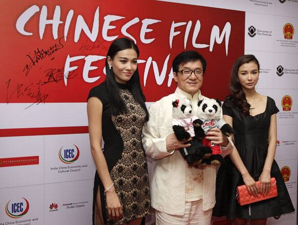 Chinese Hollywood actor Jackie Chan poses for the media with Chinese actresses Yao Xingtong, right, and Han Sanping, left, during the inauguration of Chinese film festival, in New Delhi.