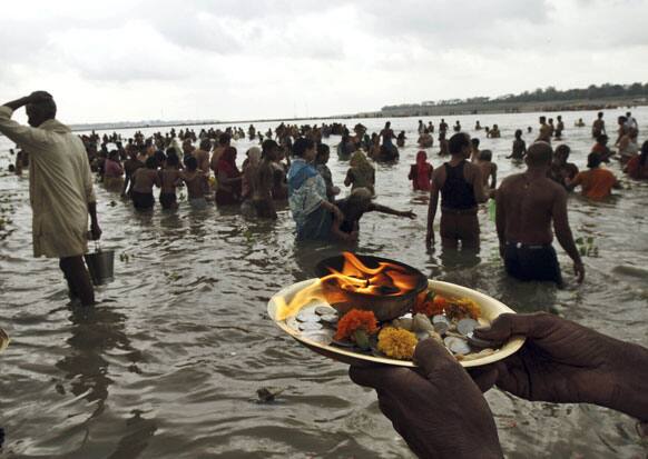 A Hindu devotee offers morning prayers on the banks of the River Ganges in Allahabad. Hindus across the country are celebrating Ganga Dussehra, devoted to the worship of the River Ganges.