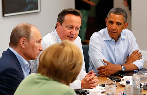 G8 leaders from left, German Chancellor Angela Merkel, Russian President Vladimir Putin, Britain`s Prime Minister David Cameron and US President Barack Obama attend a working session during the G-8 summit at the Lough Erne golf resort in Enniskillen, Northern Ireland.