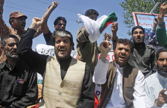 Chairman of Democratic Freedom Party and senior separatist leader Shabir Ahmad Shah, with Javid Mir, shout slogans during a protest in Srinagar.