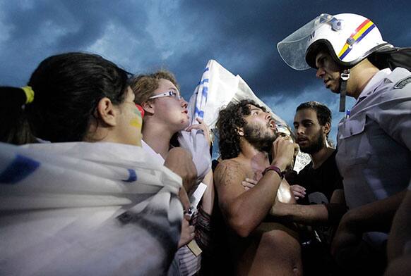 A demonstrator confronts a police officer during a protests in front of the Brazilian National Congress in Brasilia, Brazil.