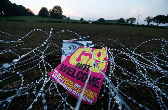 A placard is abandoned by demonstrators on a razor wire outside a security fence on the perimeter of the G-8 summit in Enniskillen, Northern Ireland.