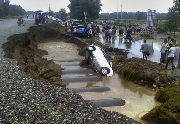 People gather at the site of a road accident on the Hardiwar-Mana national highway, in northern Indian state of Uttarakhand.