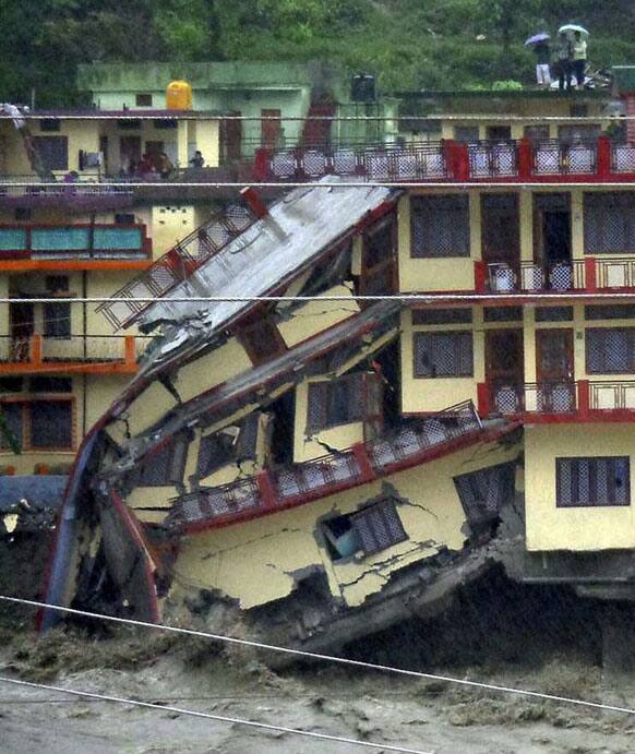 A three-story building is destroyed by floodwaters, in Uttarkashi, in northern Indian state of Uttarakhand.