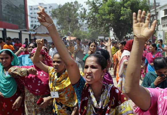 Bangladeshi women workers shout slogans as they participate in a protest outside a garment factory in Dhaka, Bangladesh.