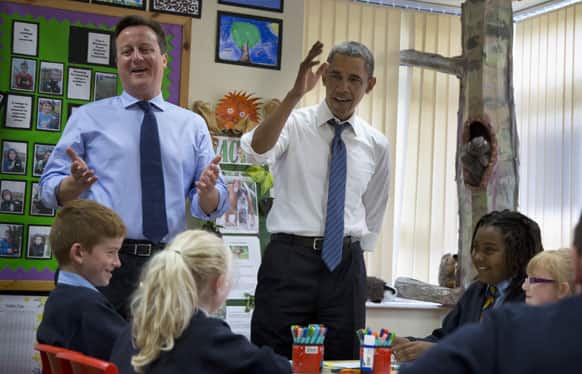 President Barack Obama and British Prime Minister David Cameron watch as students work on a school project about the G-8 summit during a visit to the Enniskillen Integrated Primary School in Enniskillen, Northern Ireland.
