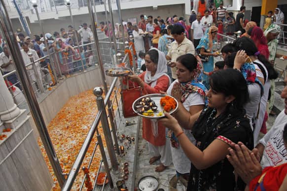 Kashmiri Hindu migrant devotees pray at the Kheer Bhawani temple during an annual Hindu festival in Jammu.