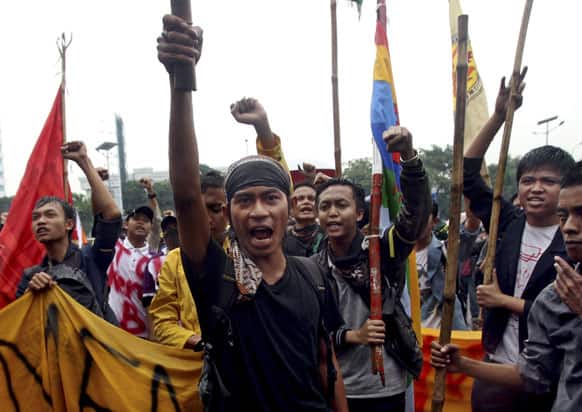 Student protesters shout slogans during a rally against the government`s plan to raise fuel prices outside the parliament building in Jakarta.