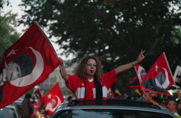 Turkish protesters wave national flags with portraits of Turkey`s founder Kemal Ataturk as they take part in an anti-government rally in Ankara.