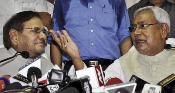 Janata Dal (United), a powerful group in eastern Bihar state, chief Sharad Yadav, left, sits with Bihar Chief Minister Nitish Kumar during a press conference in Patna.
