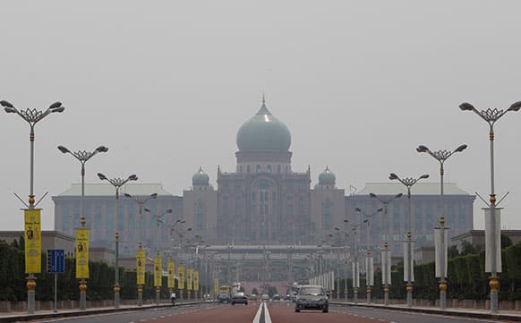 Motorists drive vehicles near the prime minister`s office on a hazy day in Putrajaya, Malaysia.