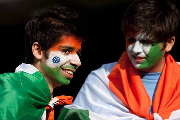 Supporters with painted faces wait for play to begin as rain falls during India`s ICC Champions Trophy cricket match against Pakistan at Edgbaston cricket ground, Birmingham, England.