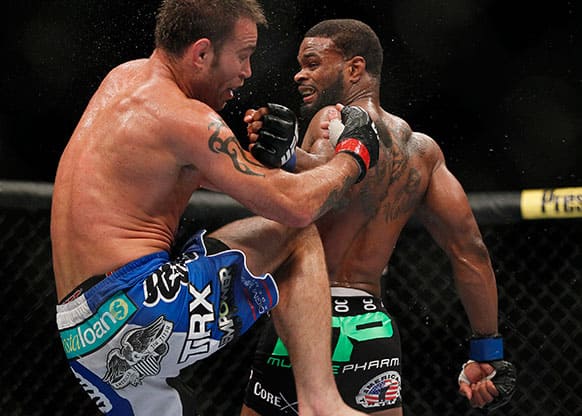 Tyron Woodley, right, connects to the head of Jake Shields, left, with a reverse punch during their welterweight bout at UFC 161 in Winnipeg.