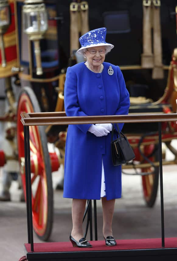 Britain`s Queen Elizabeth II as the Guards march past outside Buckingham Palace after the Trooping The Colour, at the Horse Guards Parade in London.