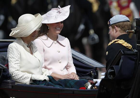 Britain`s Camilla, Duchess of Cornwall, Kate, Duchess of Cambridge, and Prince Harry leave Buckingham Palace in a horse drawn carriage for the Trooping The Colour parade, at the Horse Guards Parade in London.