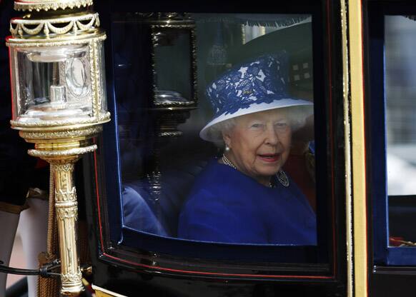 Britain`s Queen Elizabeth II leaves Buckingham Palace in a horse drawn carriage for the Trooping The Colour parade, at the Horse Guards Parade in London.