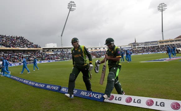 Players walk from the pitch as rain begins to fall during India`s ICC Champions Trophy cricket match against Pakistan at Edgbaston cricket ground, Birmingham, England.