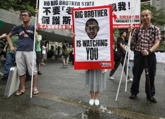 Supporters of Edward Snowden, a former CIA employee who leaked top-secret information about US surveillance programs hold placards as they march to the Consulate General of the United States in Hong Kong as they accused the US government of infringing people`s rights and privacy.