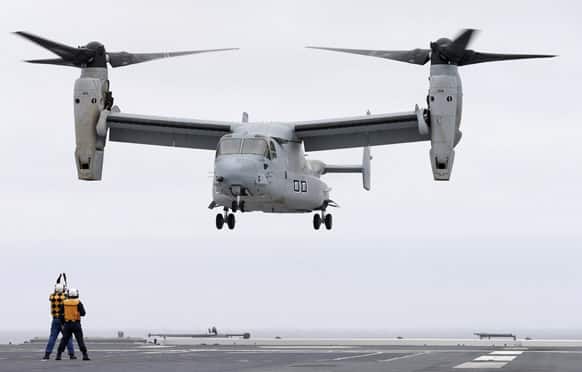 A Marine MV-22 Osprey aircraft lands on the Japanese destroyer JS Hyuga in coastal waters off San Diego. The aircraft made an unprecedented landing on the vessel Friday, despite protests in Japan over concerns over the tilt-rotor aircraft`s safety record.