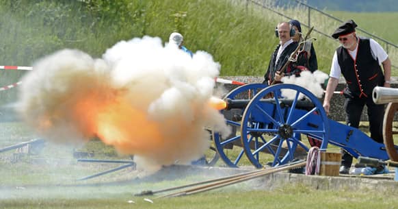 A participant fires off a historical cannon during the International Championships of field artillery gunners near Sondershausen, central Germany.