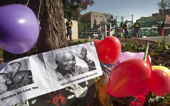 Balloons, hand-prints and get well messages left by children from the