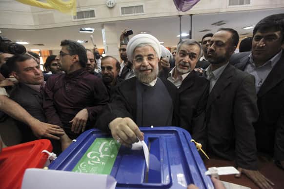 Iranian presidential candidate Hasan Rowhani, the country`s former top nuclear negotiator, casts his ballot in the presidential election at a polling station in downtown Tehran, Iran.
