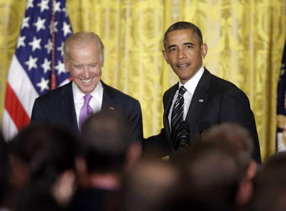 President Barack Obama with Vice President Joe Biden, on stage speaking at a reception in the East Room of the White House in Washington to celebrate lesbian, gay, bisexual, and transgender (LGBT) Pride month, Washington.