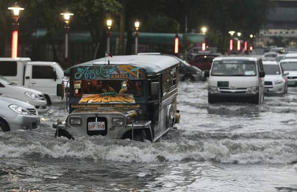 A passenger jeep crosses a flooded street in Manila, Philippines. Heavy rains caused classes to be suspended in Manila and disrupt traffic on flooded streets.