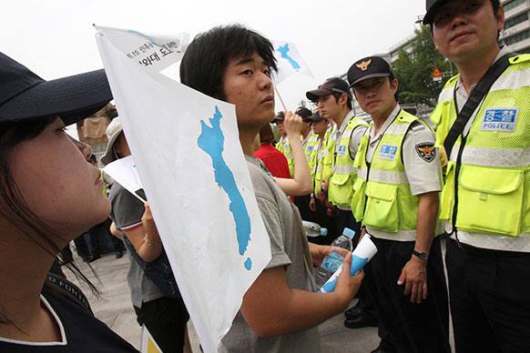 Protesters, opposing South Korean government`s policy against North Korea, confront police officers during a rally to demand resumption of the Koreas`s high-level talks near the government complex in Seoul, South Korea.