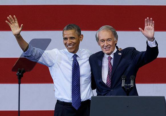 President Barack Obama and Massachusetts Democratic Senate candidate Rep. Ed Markey wave during a campaign rally For Markey in Boston`s Roxbury neighborhood.