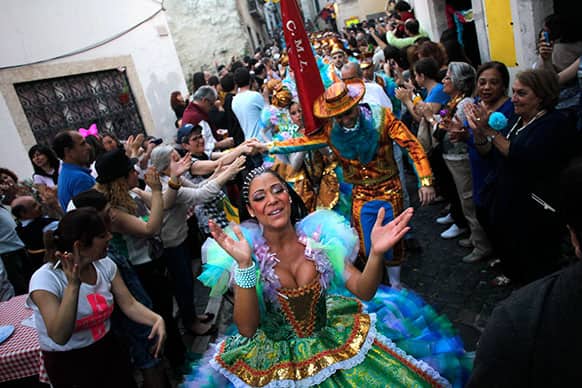 Dancers of the Alfama neighborhood group are greeted as they preapre to take part in Lisbon`s popular marches contest during Saint Anthony festivities, in Lisbon.