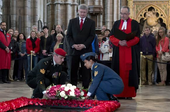 Dean of Westminster Abbey Dr. John Hall, right, stands with Canadian Prime Minister Stephen Harper as a wreath is laid by members of the Canadian Forces at the Tomb of the Unknown Warrior in Westminster Abbey in London.